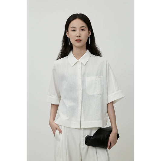 Chemise courte noire à manches courtes et col polo CAREMIND pour petit homme portant un manteau court à grandes poches