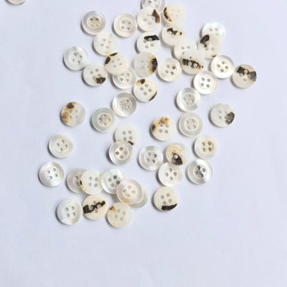 3009  Natural shell material, natural buttons, dyed buttons, spray paint dyed buttons, natural flaws, uneven