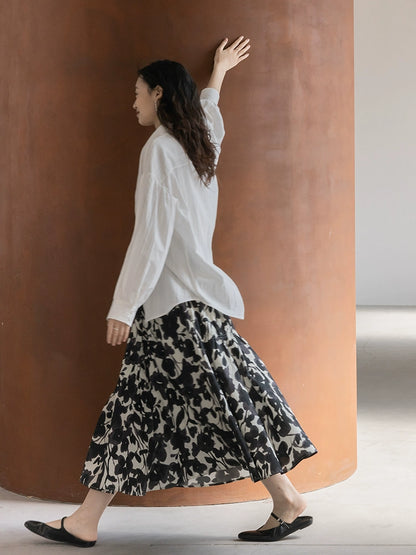 CAREMIND 24SS [refinado] falda floral de otoño para mujer cintura elástica media y larga que cubre la cadera falda en forma de A nueva 